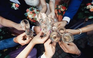 Close up of guests toasting champagne at a wedding